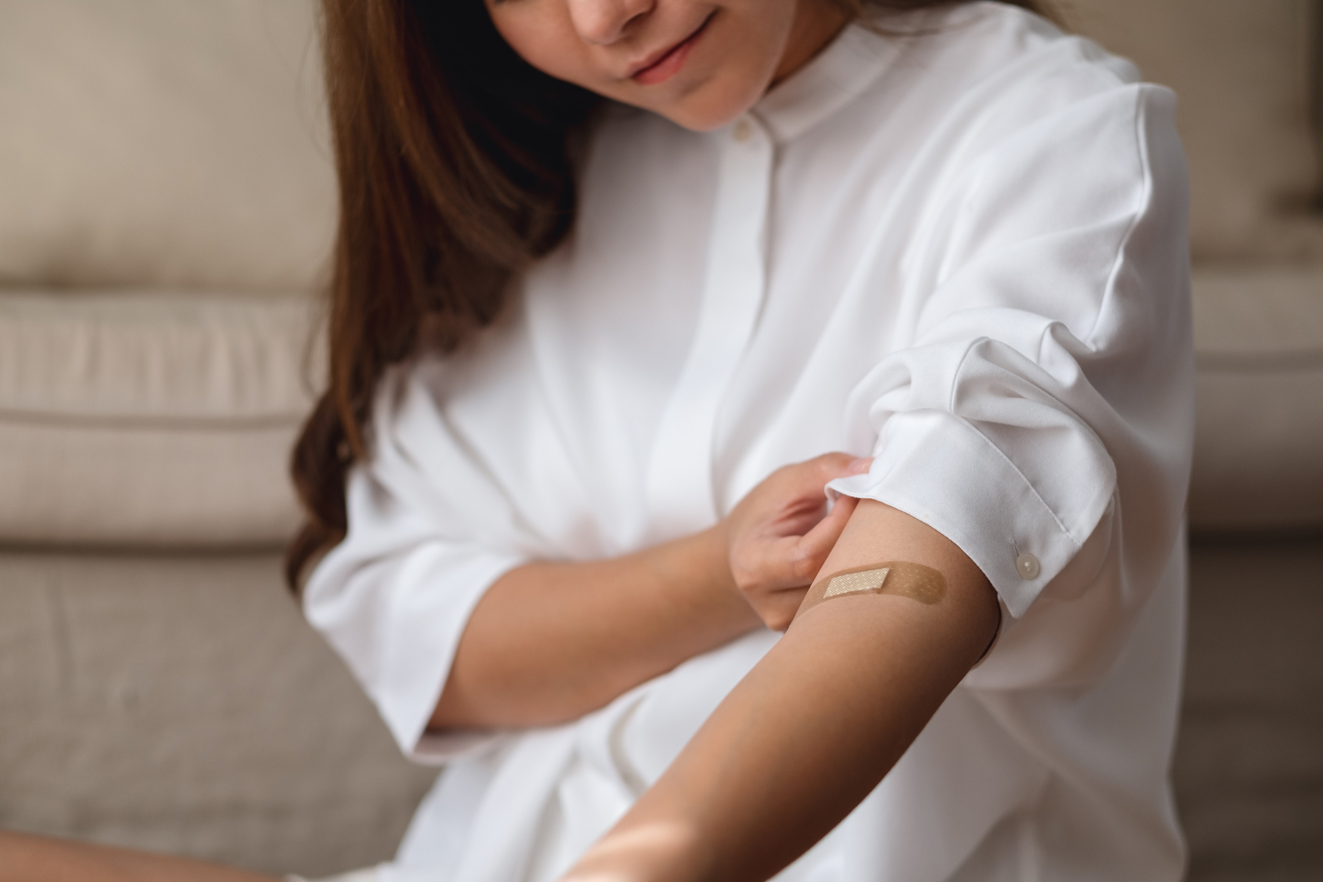 Closeup image of a young woman with adhesive bandage, medical pl